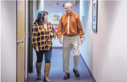  ?? ROBERTO E. ROSALES/JOURNAL ?? Yvette Pacheco and Bob Davis walk the halls at the U.S. Forest Service building on Broadway SE where they both work. Davis is retiring in January.