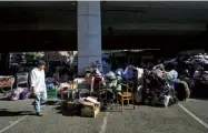  ??  ?? Volunteers sort through donations for Grenfell survivors