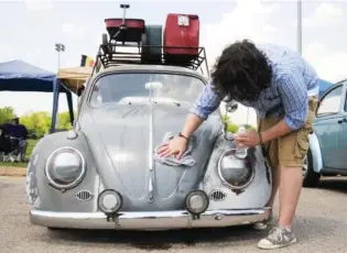  ?? STAFF FILE PHOTO BY ANGELA LEWIS ?? T. J. Johnston wipes down his 1963 Volkswagen bug at a previous Bug-A-Paluza at Camp Jordan. Expect to see about 350 people with their VWs on display.