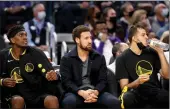  ?? Ezra Shaw / Getty Images /TNS ?? Kevon Looney, Klaythomps­on and Nemanja
Bjelica of the Golden State Warriors look
on from the bench during a game against
the Portland Trail Blazers on
Nov. 26.