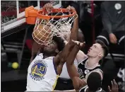  ?? KATHY WILLENS — THE ASSOCIATED PRESS ?? Warriors center James Wiseman (33) dunks in front of Nets forward Rodions Kurucs, right, during the second half on Tuesday in New York.