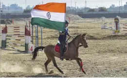  ?? — PTI ?? An equestrian holding the national flag rides as he rehearses the Defence Expo 2020 in Lucknow on Sunday. Prime Minister Narendra Modi is expected to inaugurate the mega event, to be held from February 5-9.