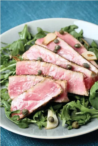  ?? | DEB LINDSEY Washington Post ?? TUNA steaks with caper sauce over rocket.