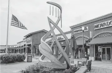  ?? ELÍAS VALVERDE II TNS ?? A memorial to victims of the Allen Premium Outlets mass shooting is seen Monday in Allen, Texas. The memorial stands 11 feet tall and has eight wind chimes, one for each of the victims of the shooting.