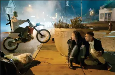  ?? Annette Brown/Universal Pictures ?? Nya (Lex Scott Davis, left) and Isaiah (Joivan Wade) hide from Purgers in “The First Purge.”