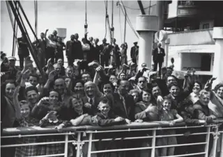  ?? © HULTON-DEUTSCH COLLECTION/CORBIS ?? Refugees cheer as their liner is allowed to berth at Antwerp, Belgium, in 1939. Many passengers nonetheles­s wound up in concentrat­ion camps after the Nazis invaded Belgium.