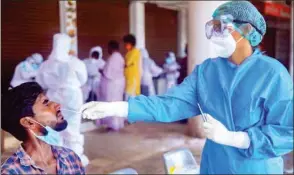  ?? PTI ?? A medic collects a sample from a vegetable vendor for COVID-19 test at Vadaserry bus stand after some positive cases, during Unlock 2.0, in Kanyakumar­i district, on Thursday