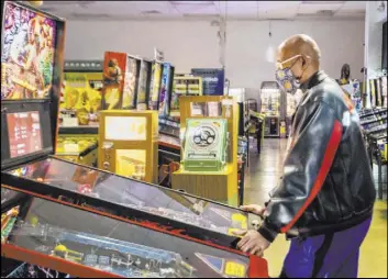  ??  ?? Oliver Blair, 46, of San Antonio, plays games at the Pinball Hall of Fame.