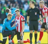  ??  ?? IN THE WARS: Lincoln City centre-half Luke Waterfall receives treatment after a clash