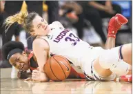  ?? Jessica Hill / Associated Press ?? UConn’s Katie Lou Samuelson, top, and Houston’s Julia Blackshell-Fair fall to the court chasing a loose ball during the first half on Saturday in Storrs. Samuelson left the game injured after the play.