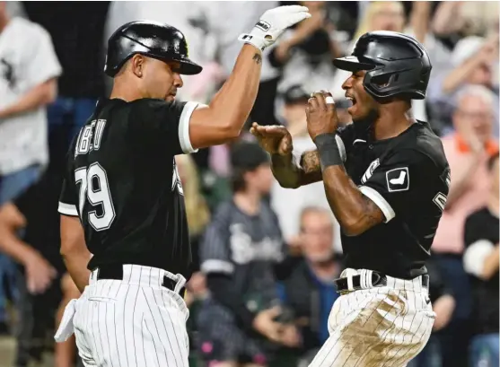  ?? QUINN HARRIS/GETTY IMAGES ?? Tim Anderson (right) celebrates with Jose Abreu after scoring the winning run on a single by Luis Robert in the ninth inning Saturday against the Yankees.