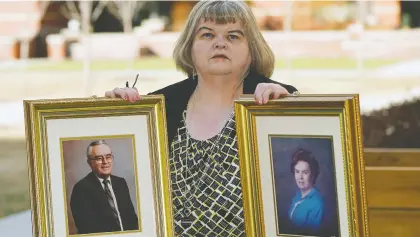  ?? LARRY WONG ?? Lynda Stewart holds portraits of her father, Lowell Stewart, and her mother, Jean Stewart, outside her home in Sherwood Park. Both of her parents were in their 90s when they died from COVID-19. Lynda also contracted the coronaviru­s and almost died, but has since recovered.