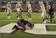  ?? LM OTERO — THE ASSOCIATED PRESS ?? TCU quarterbac­k Max Duggan (15) kneels in the end zone after rushing for a touchdown in the second half of the Big 12 Conference championsh­ip NCAA college football game against Kansas State, Saturday, Dec. 3, 2022, in Arlington, Texas.