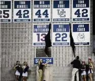  ?? Associated Press file photo ?? UConn basketball alumni Worthy Patterson and Bill Corley’s numbers are unveiled after the two were inducted into the Huskies of Honor during halftime of UConn’s NCAA basketball game against DePaul in Storrs on Feb. 15, 2012.