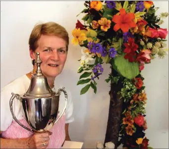  ??  ?? Kathleen Reidy, Camp, Castleisla­nd, with her show-topping flower arrangemen­t, with which she won the Féile Na mBláth Cup for a fourth time.