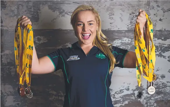  ?? Picture:DAVE LEANE ?? Canoe sprinter Isabelle Rositano with the medals she had won while holding the national champion title for four years.