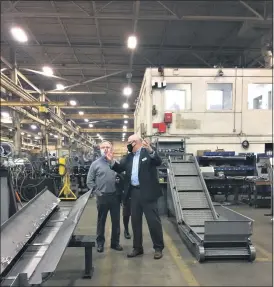  ?? PHOTOS BY SHEENA HOLLAND DOLAN — THE NEWS-HERALD ?? Mayfran Internatio­nal President Frank Sraj, right, gives U.S. Rep. Dave Joyce a tour around the Mayfield Village machining factory.