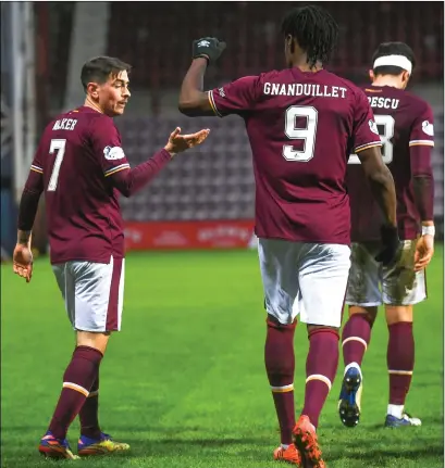  ??  ?? Jamie Walker is congratula­ted for giving Hearts the lead after goalkeeper Craig Gordon, below, had thwarted the visitors