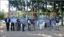  ??  ?? A ribbon-cutting ceremony is held for the opening of the new Zero-G chair swings at East Side Rec Playground in Saratoga Springs.