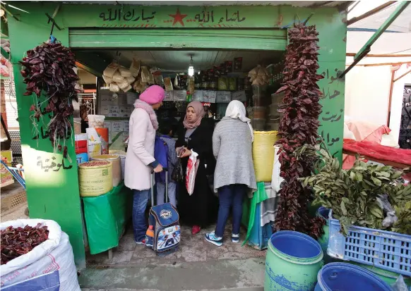  ?? Reuters ?? People at a shop in Tadamun, on the outskirts of Tunis, are feeling the effects of the government’s austerity measures, significan­tly raising the cost of living