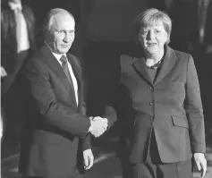  ??  ?? File photo shows Merkel (right) shaking hands with Putin at the Chanceller­y in Berlin. — AFP photo