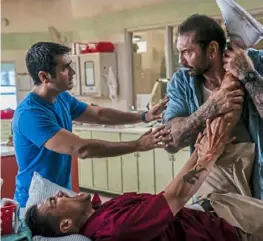  ?? Hopper Stone/ SMPSP ?? Kumail Nanjiani, left, cautions Dave Bautista, right, as he forcefully questions Rene Moran in “Stuber.”