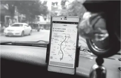  ??  ?? A taxi driver using the Didi Chuxing app while driving along a street in Guilin in Guangxi Zhuang Autonomous Region. China’s transport ministry on Sunday slammed Didi Chuxing’s safety lapses as the ride-hailing giant said it would suspend its Hitch service after the rape and murder of a passenger, the second such killing this year. — AFP