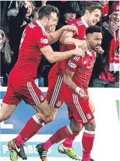  ??  ?? The Dons celebrate Logan’s winner.