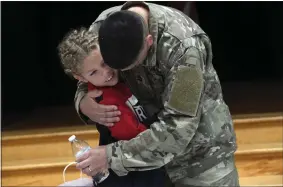  ?? BILL UHRICH -MEDIANEWS GROUP ?? Jose Lopez, who retired from the Army last year after serving for 22years, hugs his 9-yearold son, Rey, a fourth-grader at Lorane Elementary School, following the school’s Veterans Day celebratio­n.