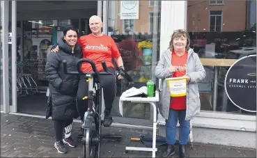  ?? (Photo: Katie Glavin) ?? Minnie Irene O’Donnell (left) and Breda Mannix supporting Patty Smyth spinning outside Herlihy’s Centra in Fermoy in aid of Marymount Hospice.