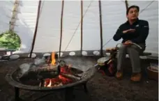  ??  ?? Cultural interprete­r Joshua LeClair preps to smudge at Anishinaab­e Camp.