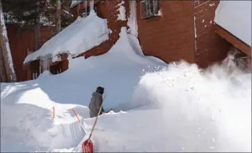  ?? Photos by Hector Yanez ?? Mammoth could look a lot more like this, this weekend as a series of storms bear down on the region for the Easter weekend. Here, Jairo Yanez helps clear out the snow from a storm earlier this month.