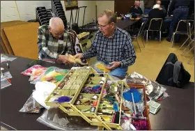  ?? NWA Democrat-Gazette/FLIP PUTTHOFF ?? Don Chapman (right) taught fly tying in Bella Vista for 27 years before handing over the teaching duties. Chapman remains a fixture with the Bella Vista Fly Tyers, chatting here with a fellow tyer.