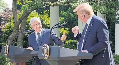  ?? EVAN VUCCI THE ASSOCIATED PRESS ?? Mexican President Andres Manuel Lopez Obrador and U.S. President Donald Trump gesture before signing a joint declaratio­n of solidarity at the White House on Wednesday, celebratin­g North America’s new trade deal — without Canada.