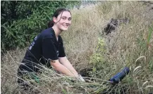  ?? PHOTO: KAYLA HODGE ?? Many hands, light work . . . Student Volunteer Army member Francesca Holdcroft, of Canterbury, helps Forest and Bird with planting at Cape Wanbrow on Saturday.