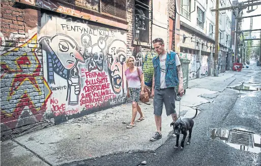  ?? DARRYL DYCK PHOTOS/THE CANADIAN PRESS ?? Trey Helten, right, speaks with drug user Gina McEwen while walking his dog Princess Zelda in the Downtown Eastside of Vancouver.