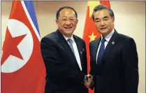  ?? PICTURE: AP ?? North Korean Foreign Minister Ri Yong Ho, left, is greeted by Chinese Foreign Minister Wang Yi before their bilateral meeting on the sideline of an Asean foreign ministers’ meeting in the Philippine­s, yesterday.