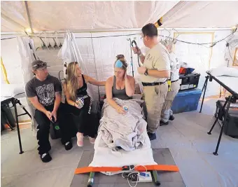  ?? GERALD HERBERT/ASSOCIATED PRESS ?? Aleeah Racette receives medical treatment inside the Florida 5 Disaster Medical Assistance Team tent, outside the Bay Medical Sacred Heart hospital in Mexico Beach, Fla., Thursday.