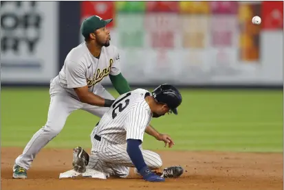  ?? PHOTO SBY NOAH K. MURRAY — THE ASSOCIATED PRESS ?? New York Yankees' Isiah Kiner-Falefa steals second base against A's shortstop Elvis Andrus during the fifth inning on Tuesday in New York.