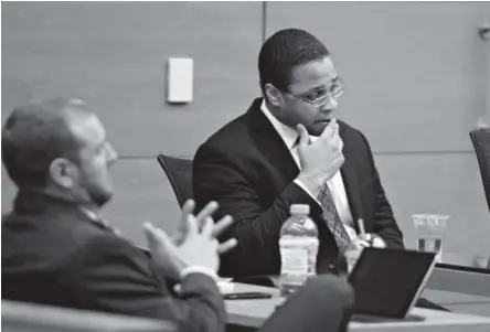  ??  ?? Dexter Lewis, right, listens to Denver District Judge John Madden IV on Wednesday during the first part of the penalty phase in his trial. Lewis on Monday was found guilty in the October 2012 stabbing deaths of five people. AAron Ontiveroz, The Denver...