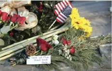  ?? | AP ?? FLOWERS and a note hailing former President George HW Bush as “one of the good guys” were part of a makeshift memorial near Walker’s Point, the Bush’s summer home in Kennebunkp­ort, Maine, on Saturday.