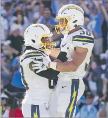  ?? Robert Gauthier Los Angeles Times ?? THE CHARGERS’ Austin Ekeler (30) celebrates with Virgil Green after scoring in overtime. Ekeler had 154 total yards.