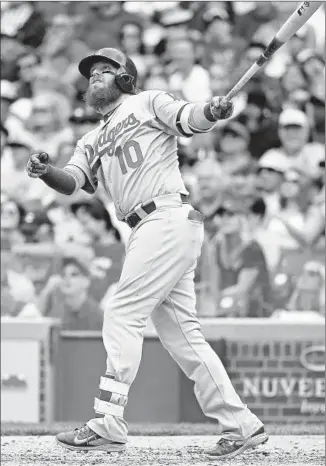  ?? Jonathan Daniel
Getty I mages ?? JUSTIN TURNER of the Dodgers watches his seventh- inning hit that was originally ruled a home run, then changed to a triple after a review. Turner has a team- high .324 batting average.