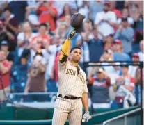  ?? NICK WASS/AP ?? Juan Soto raises his batting helmet to the crowd before his at-bat during the first inning Friday night against the Nationals. For the first time in his four-year career, the newest member of the San Diego Padres was in D.C. and playing for the road team.