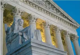  ?? PATRICK SEMANSKY/AP 2022 ?? Part of the Supreme Court Building is illuminate­d on Capitol Hill.