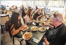  ?? ELIZA GREEN / THE CALIFORNIA­N ?? Customers enjoy their meals during a weekday lunch rush at Chef’s Choice Noodle Bar.
