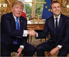  ??  ?? Handshake: Trump and Macron yesterday
