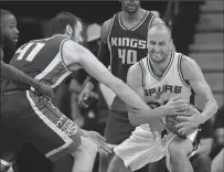  ?? Associated Press ?? Sacramento Kings center Kosta Koufos tries to strip the ball from San Antonio Spurs guard Manu Ginobili during the second half of Wednesday’s game in San Antonio. The Spurs won 114-104.