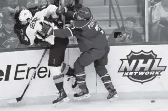  ??  ?? Minnesota forward Chris Porter checks Colorado defenseman Eric Gelinas into the boards during theWild’s 6- 3 victory over the Avalanche on Tuesday in St. Paul, Minn. Ann Heisenfelt, The Associated Press