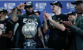  ?? ASSOCIATED PRESS ?? Cleveland Cavaliers superstar LeBron James salutes after his team was presented the trophy for beating the Boston Celtics in the Eastern Conference finals. James will be playing in his eighth straight NBA Finals.